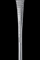 A copper bar placed next to a certificate of lab testing for purity.