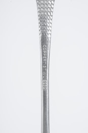 A close-up view of a metallic object with a textured surface and engraved text reading 'COPPERIST.WU S925'. The handle tapers from narrow to wide, showcasing a shiny silver finish against a plain background.