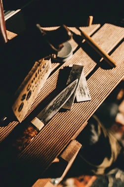 Close-up of a bright, hand-thrown stoneware knife resting on a wooden table with soft natural light.