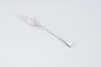 Close-up of a sleek, modern kitchen utensil in use, highlighting its ergonomic design.