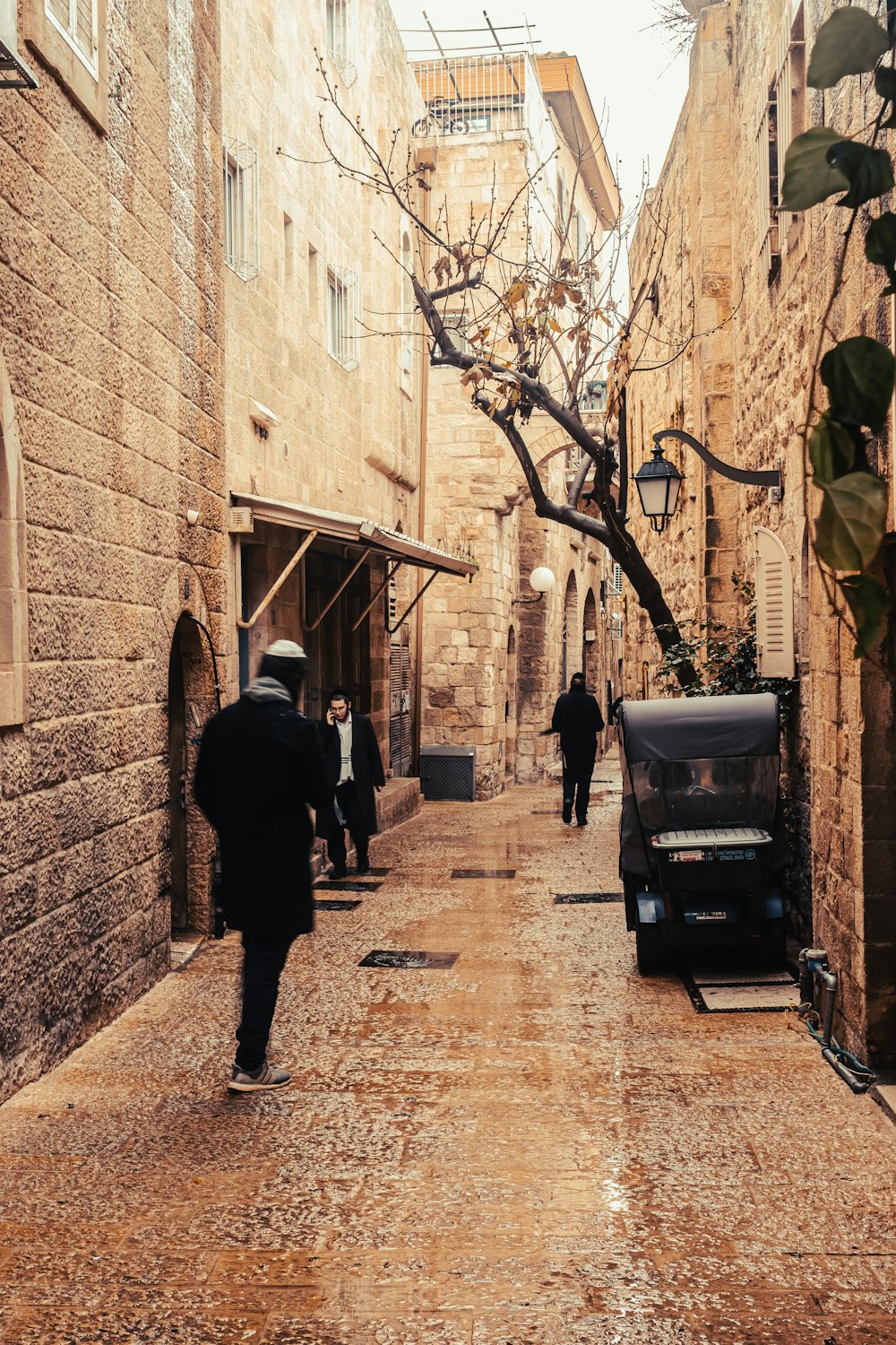 a man walking down a narrow alley way