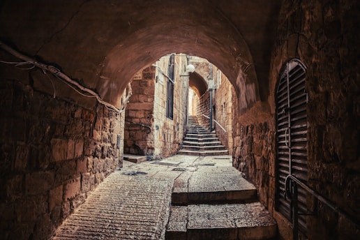 a narrow tunnel with steps leading up to it