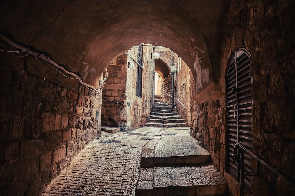 a narrow tunnel with steps leading up to it