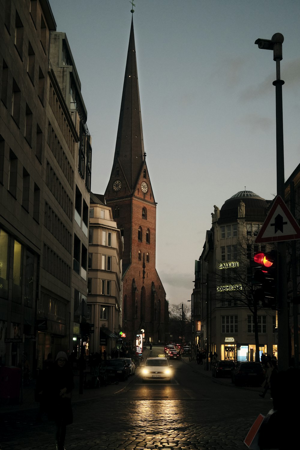 a car driving down a street next to tall buildings