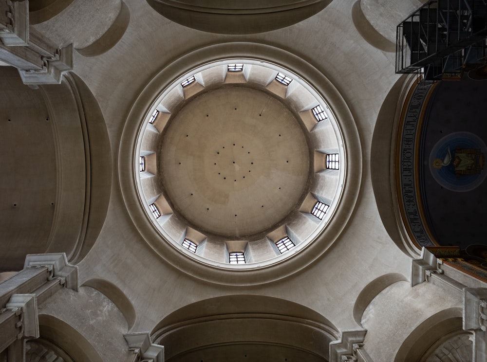 the ceiling of a building with a circular window