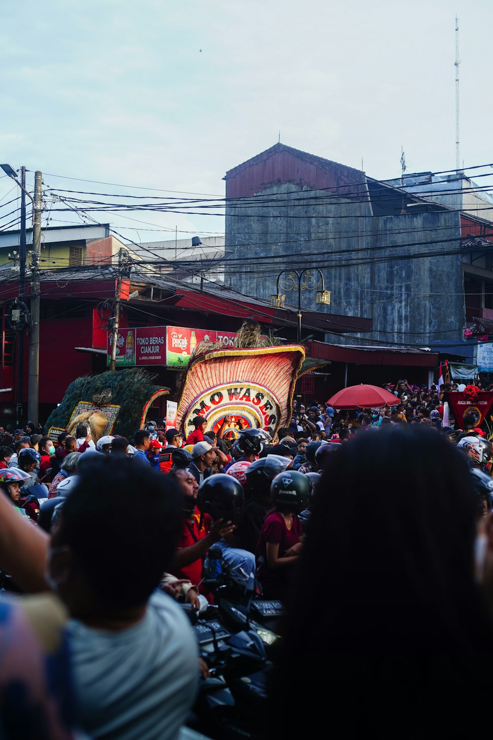 a crowd of people standing around a carnival float