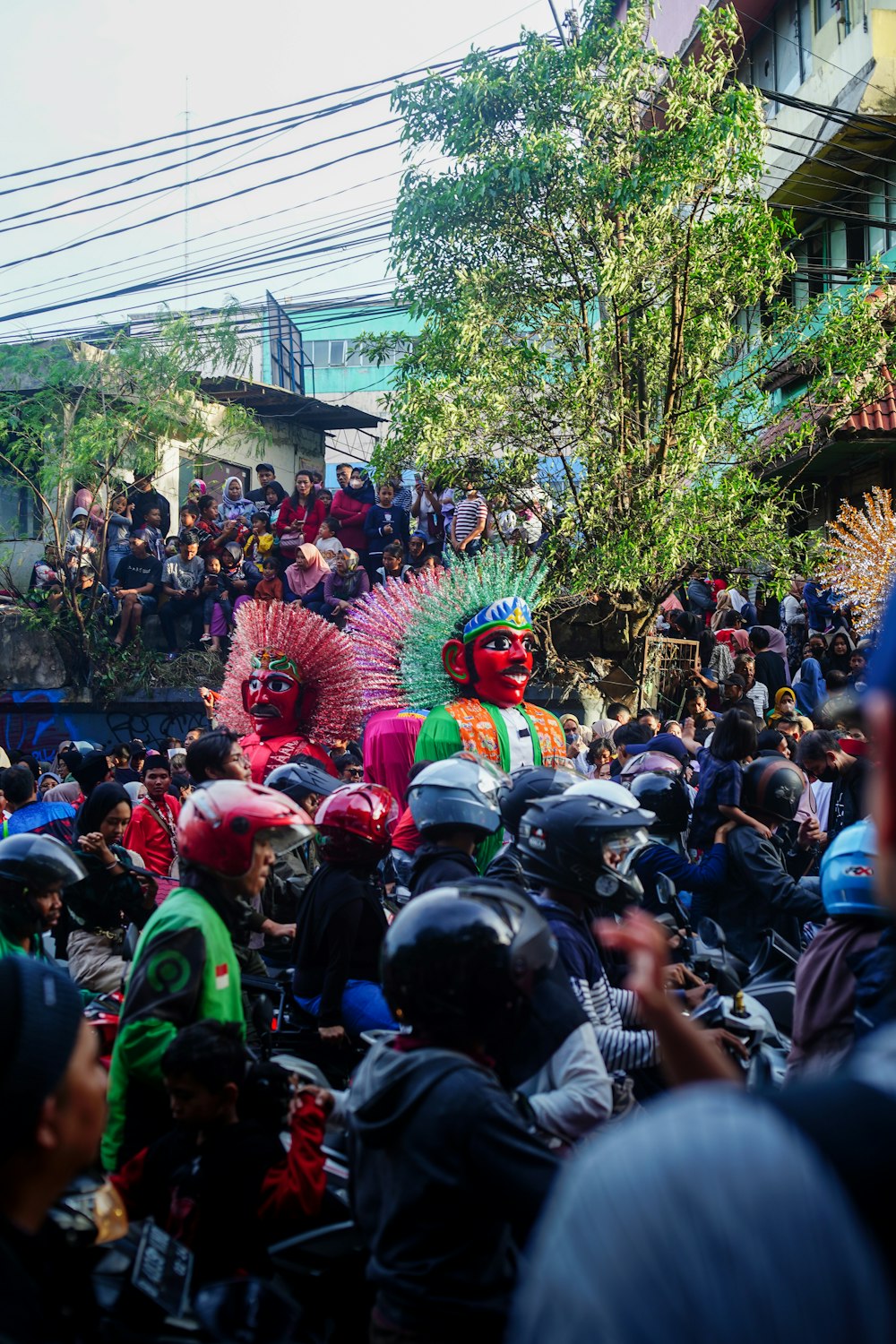 a group of people riding motorcycles down a street