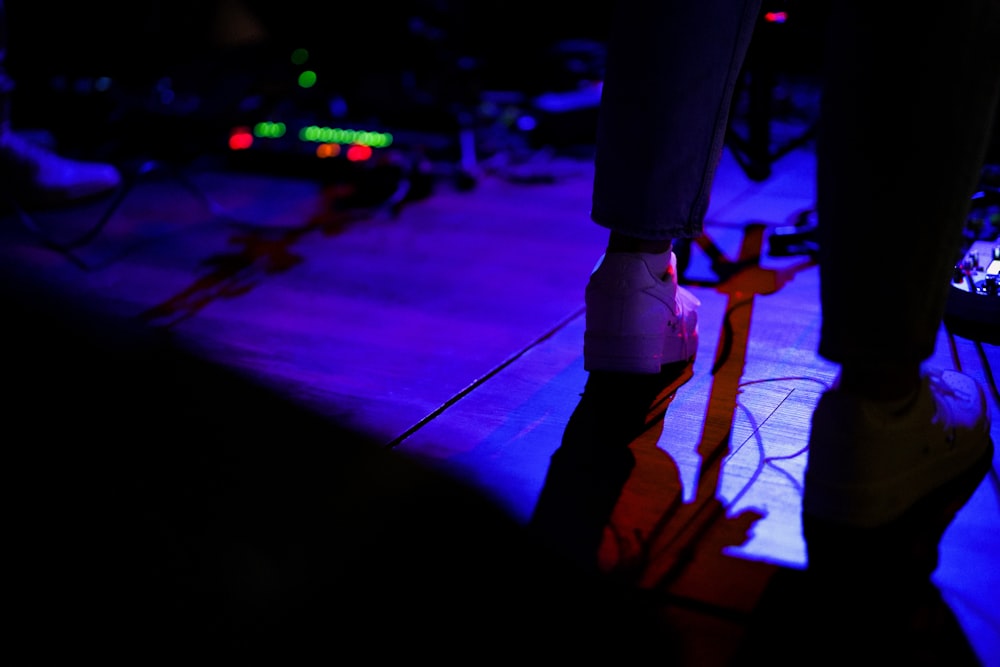 a person standing on a stage in the dark