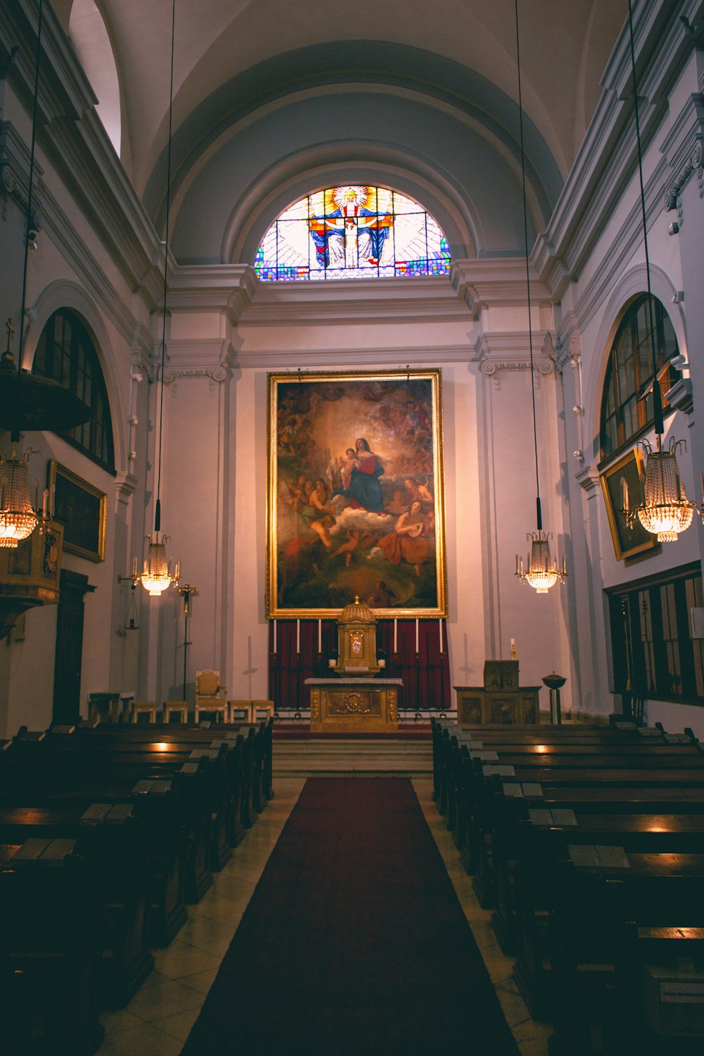 the interior of a church with a painting on the wall