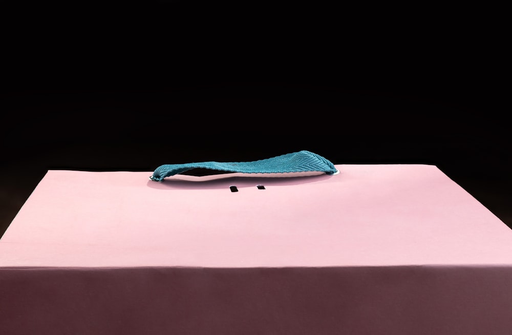 a pink table with a blue cloth on top of it