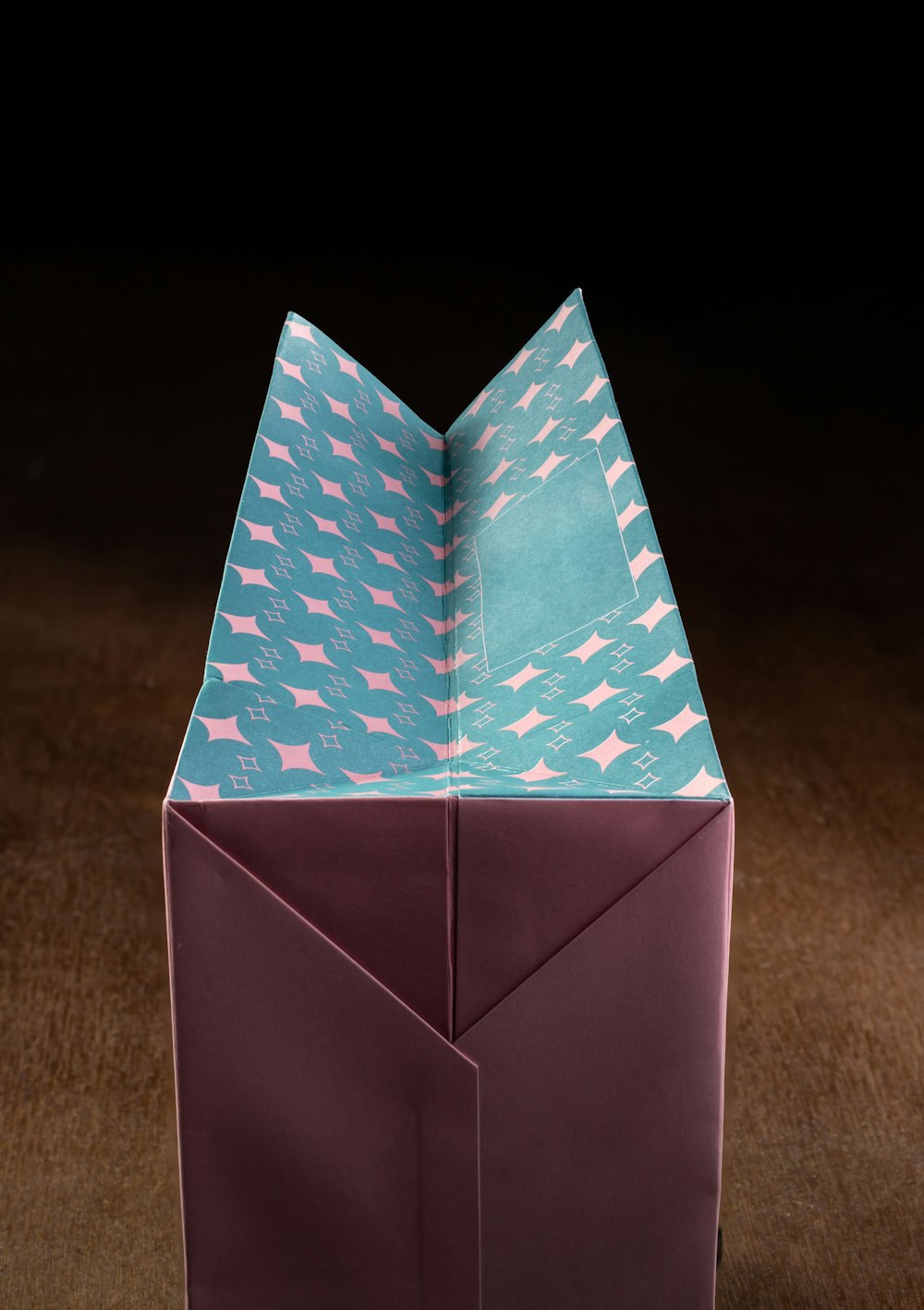 an origami box with a piece of paper folded over it