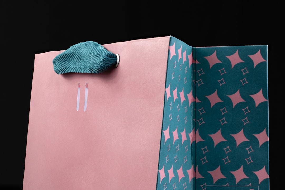 Closeup shot of a pink paper shopping bag on dark background