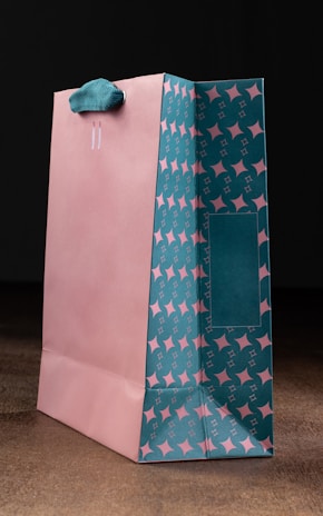 a pink and blue shopping bag with stars on it