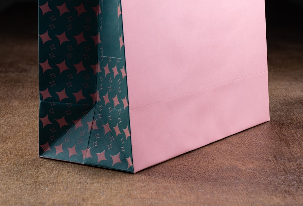 a pink and green shopping bag with stars on it