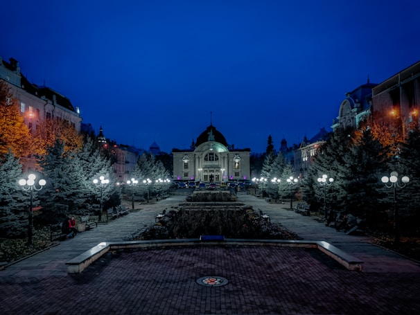 A serene evening scene of the cinema building glowing softly against the night