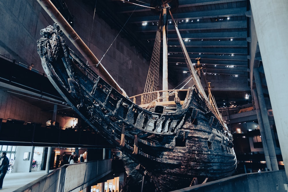 a large wooden boat sitting inside of a building