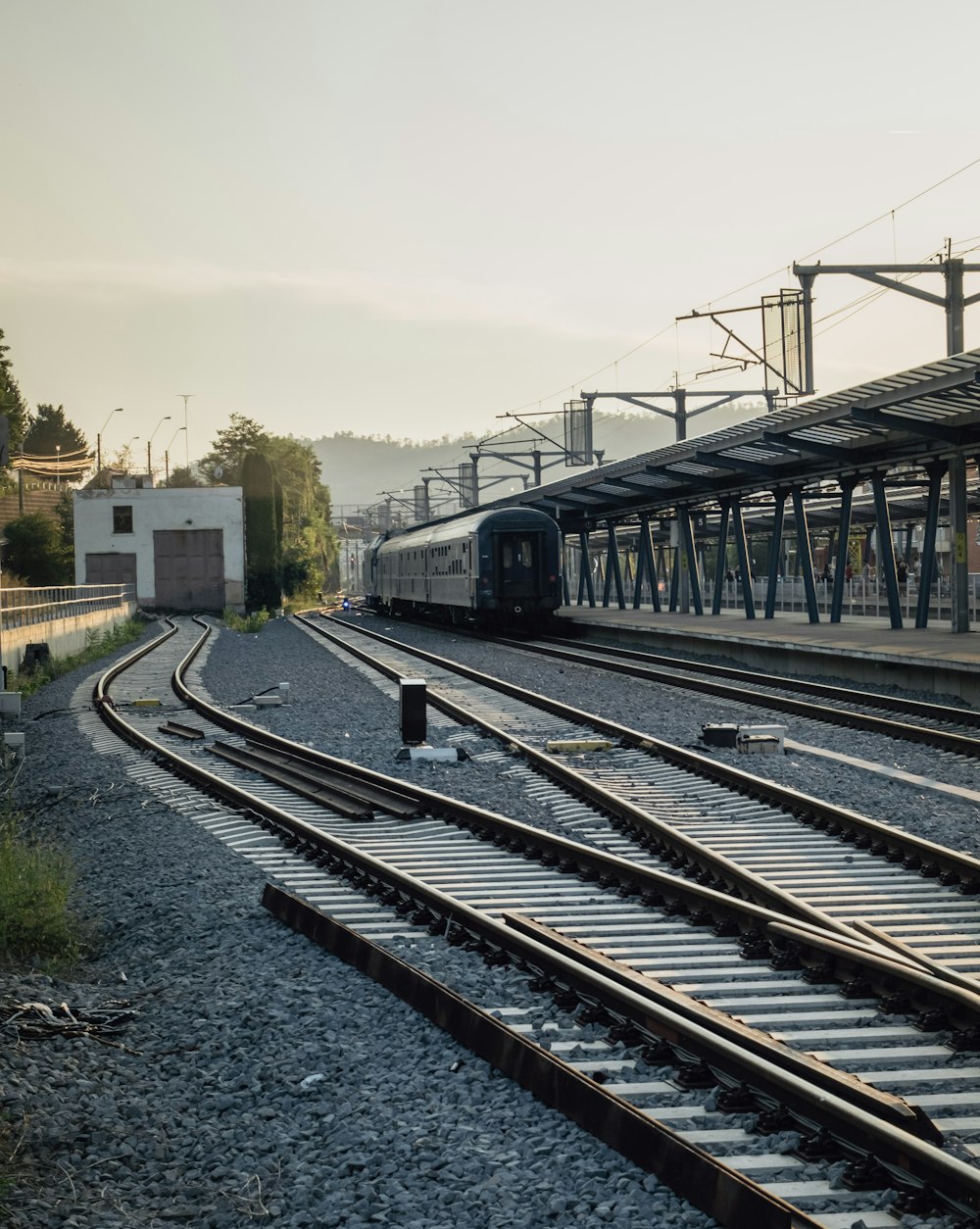 a train traveling down train tracks next to a train station