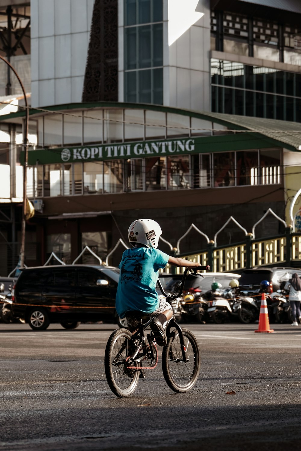 a person riding a bike on a city street