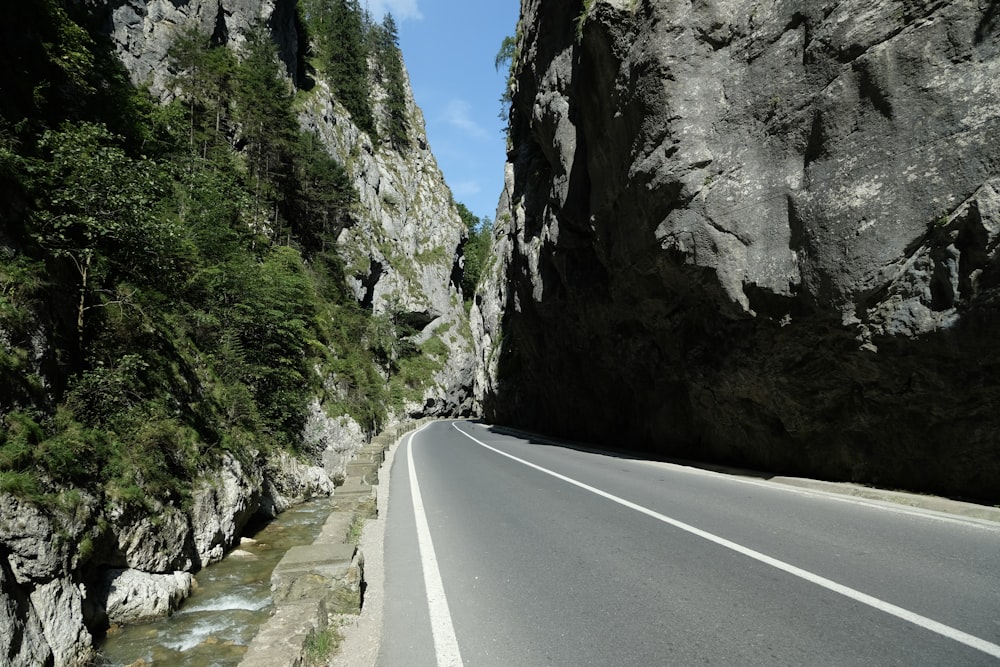 a car driving down a road next to a river