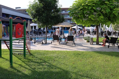 A vibrant community area with a pool and loungers.