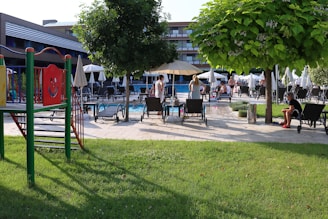 A vibrant community area with a pool and loungers.