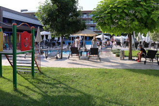 A vibrant modern hospitality complex with families enjoying various recreational activities.