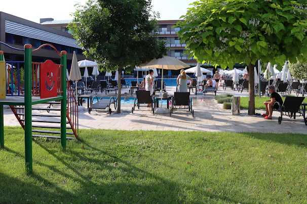 A vibrant modern hospitality complex with families enjoying various recreational activities.