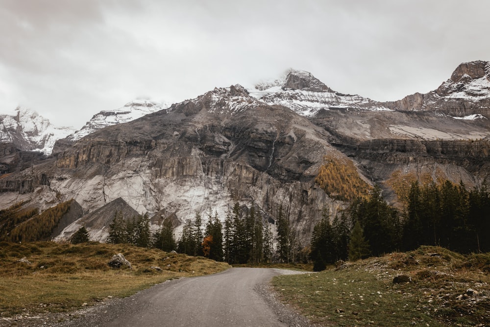 a road leading to a mountain with snow on it