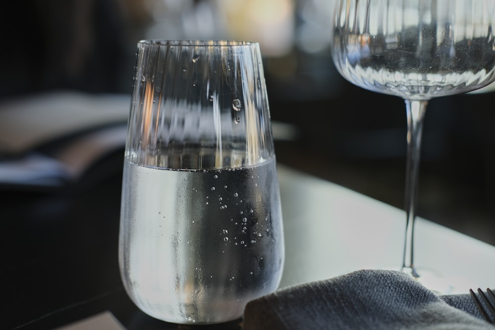 a glass of water and a wine glass on a table