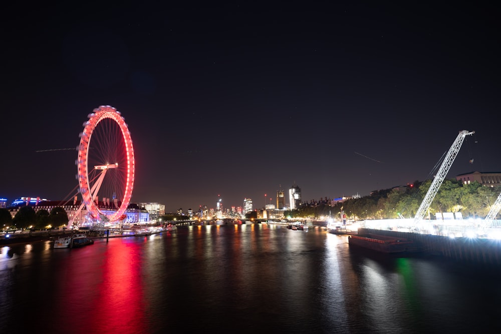 a ferris wheel lit up in the night sky