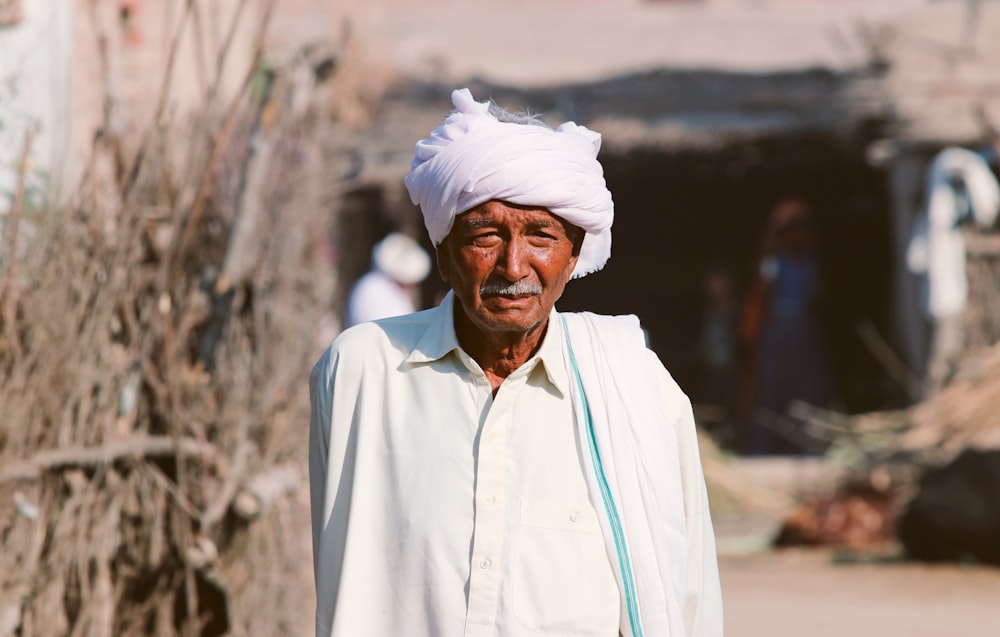an old man with a white turban on his head