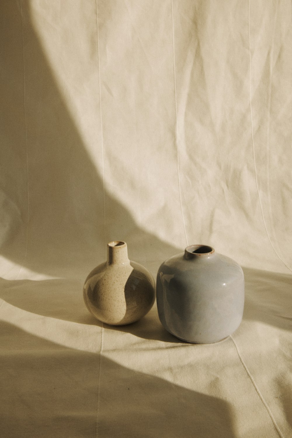 a couple of vases sitting on top of a table