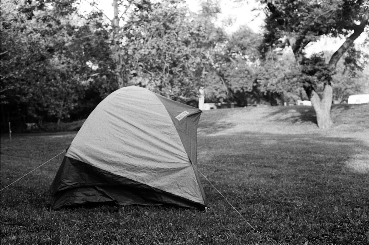 a tent sitting in the middle of a park
