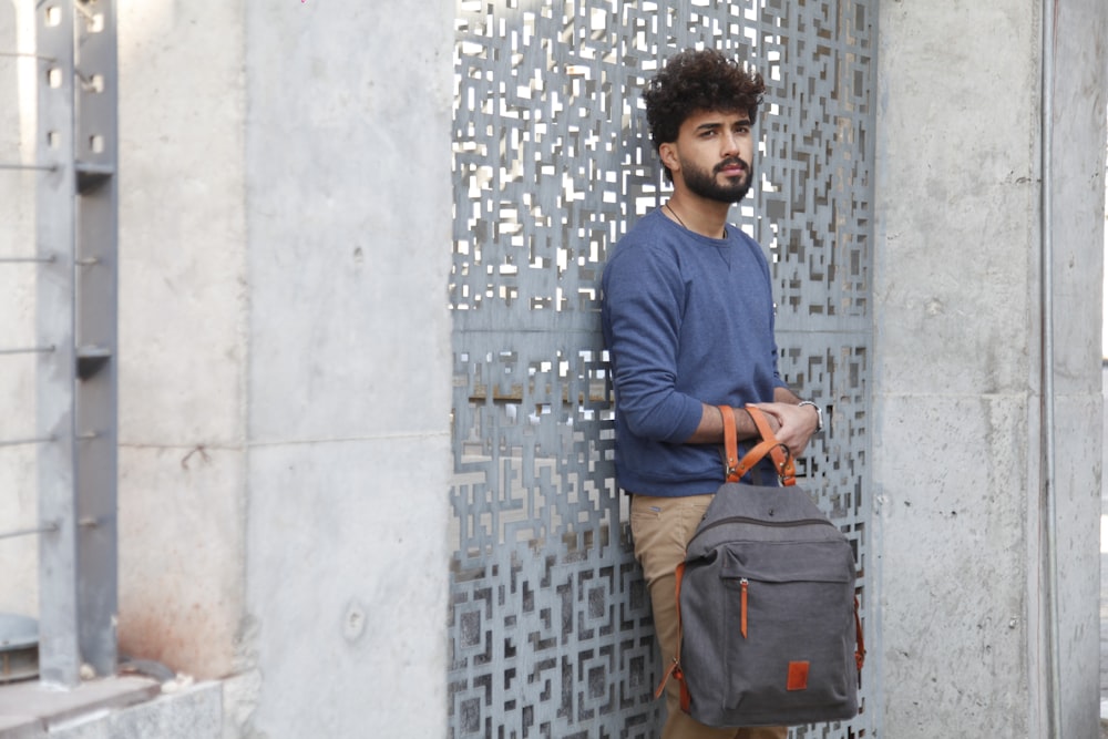 a man with a beard is holding a bag