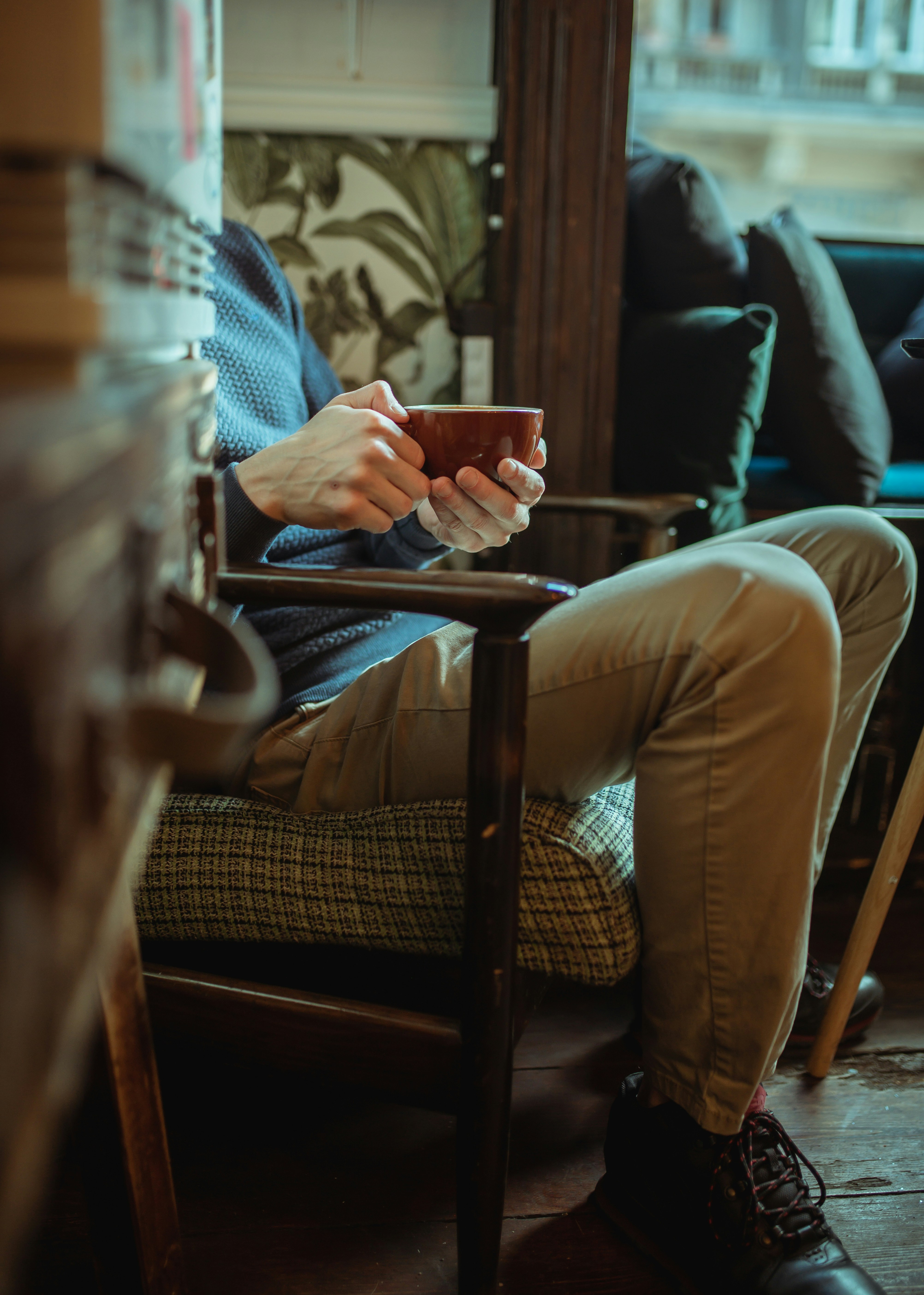 a man sitting in a chair holding a cell phone