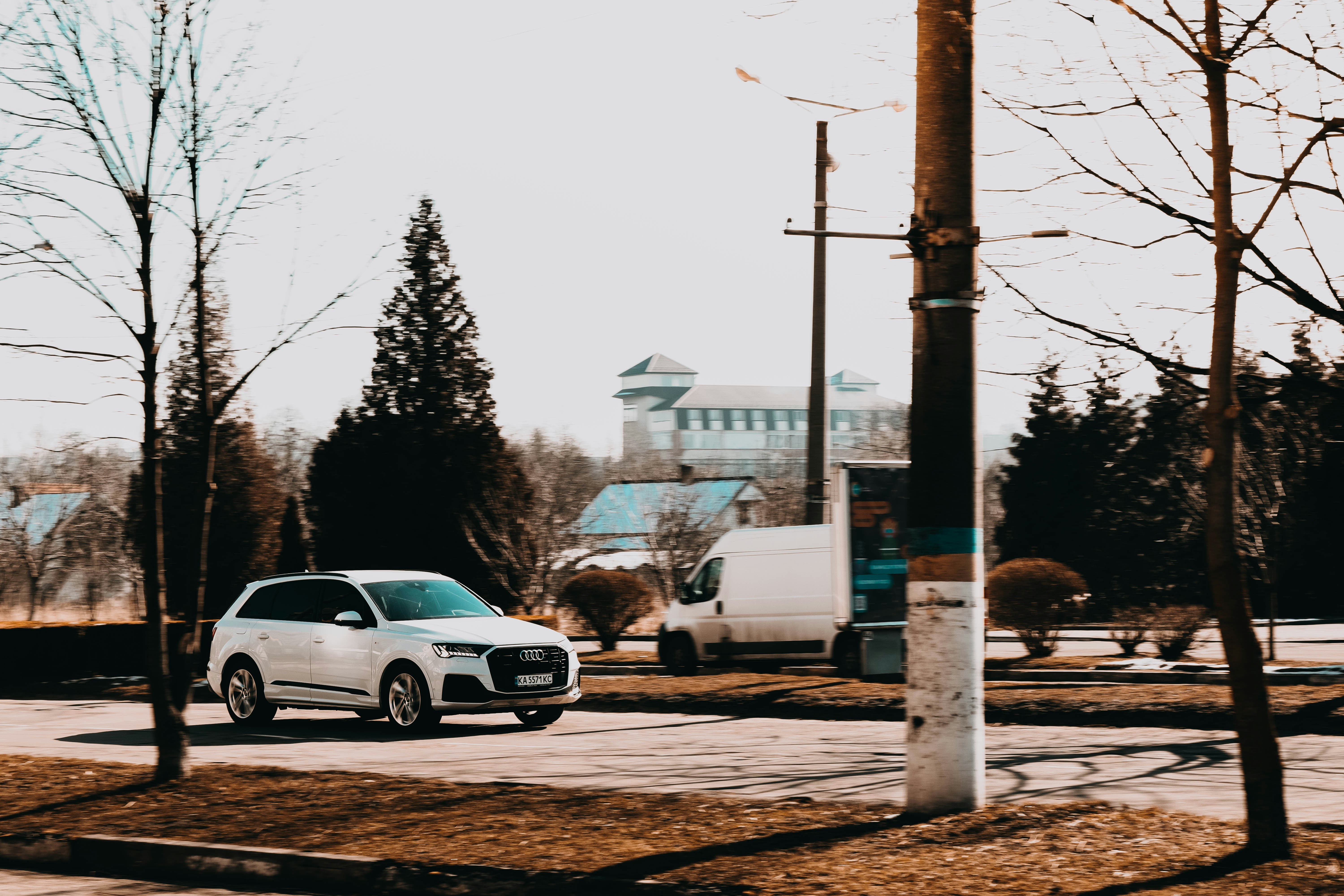 a white car is parked in a parking lot