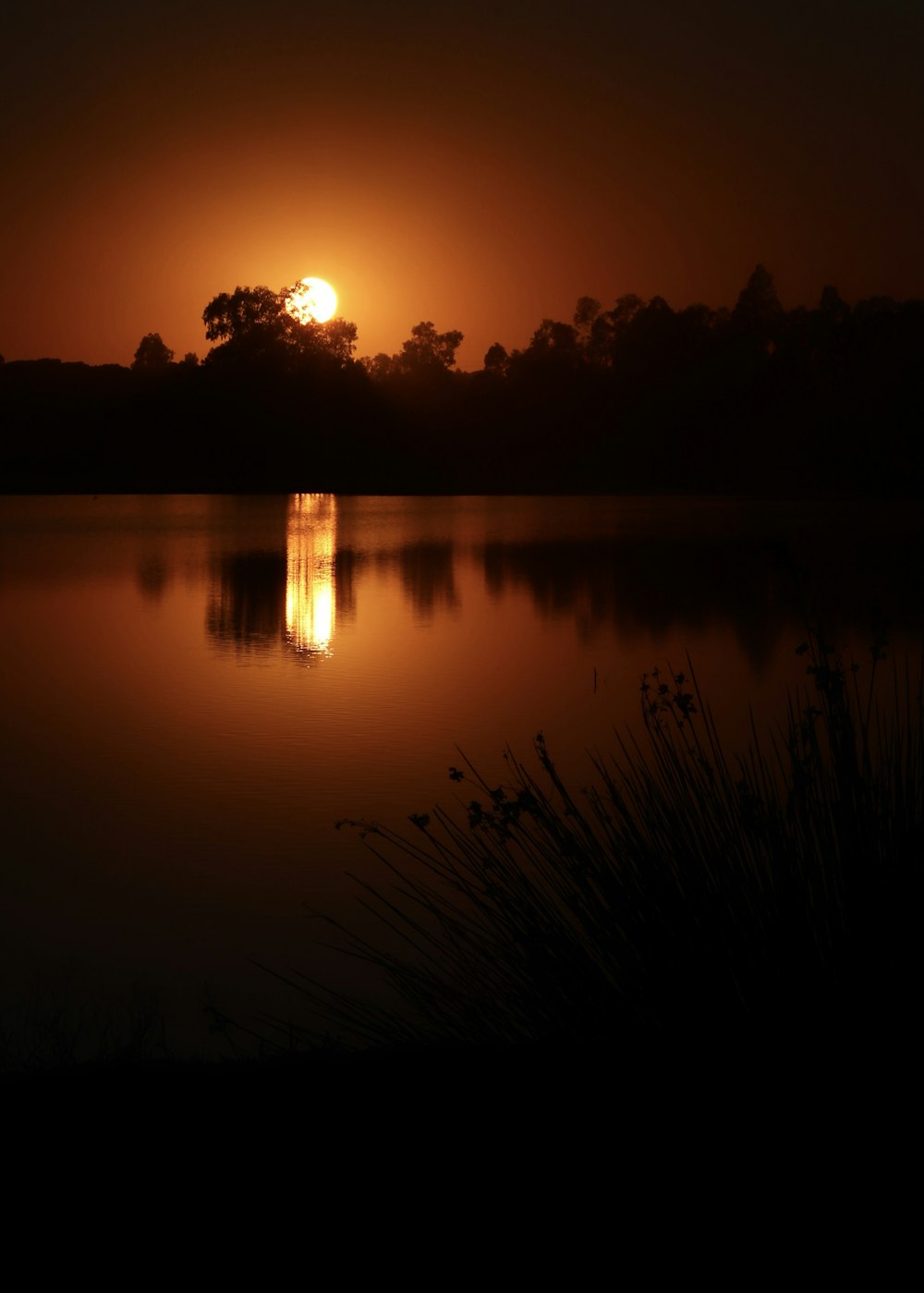 the sun is setting over a body of water