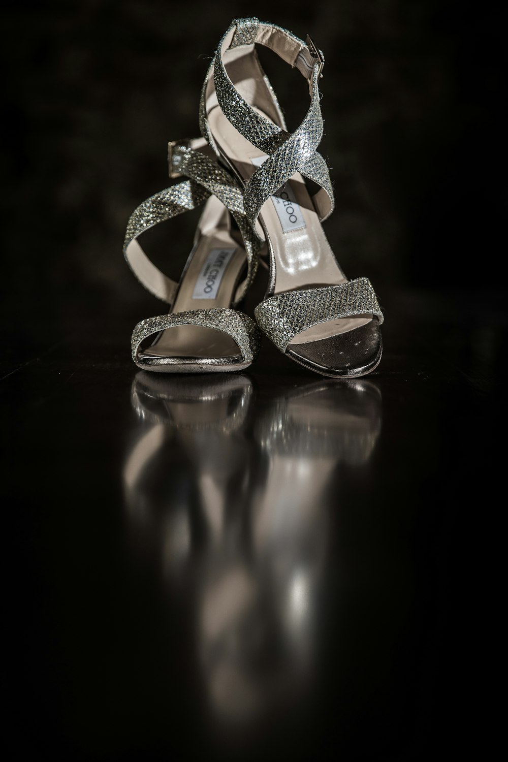 a pair of high heeled shoes sitting on top of a table