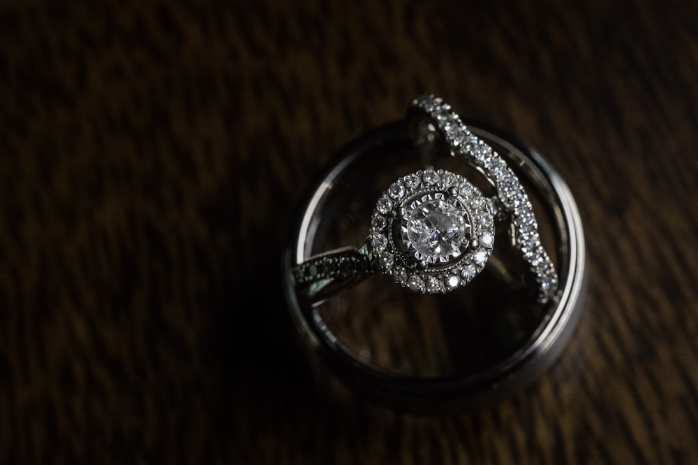 a close up of a diamond ring on a table