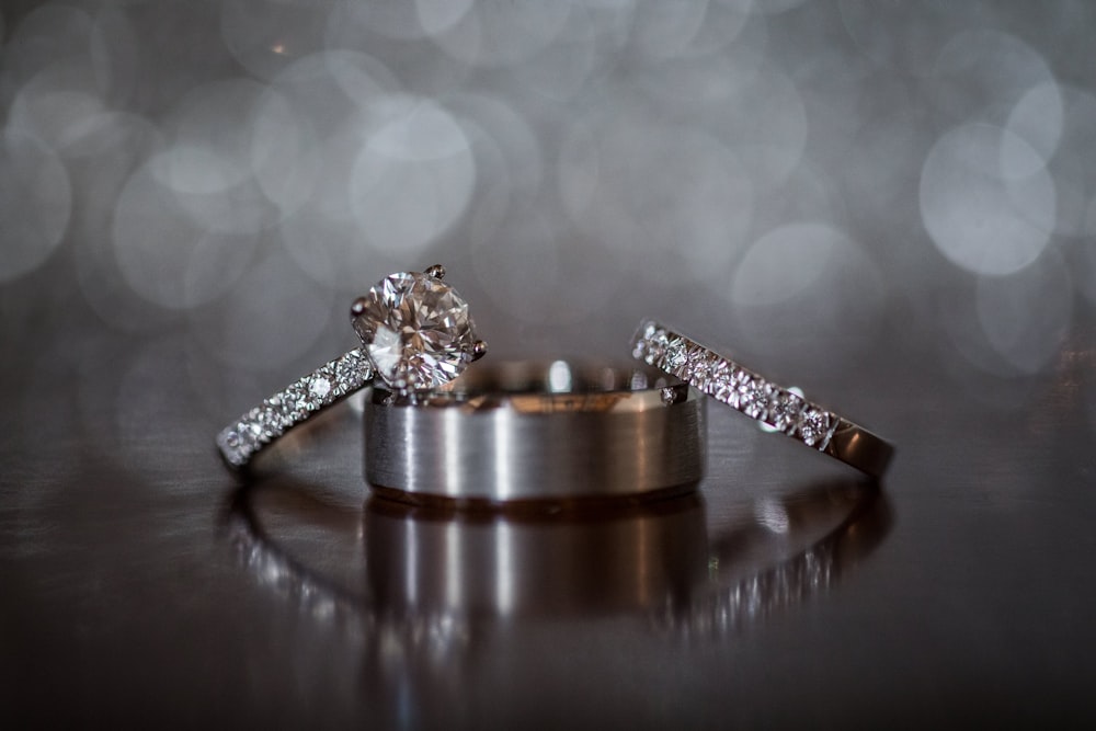 a couple of wedding rings sitting on top of a table