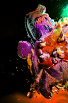 Close-up of layered mixed media textures with bold strokes of orange and deep purple.