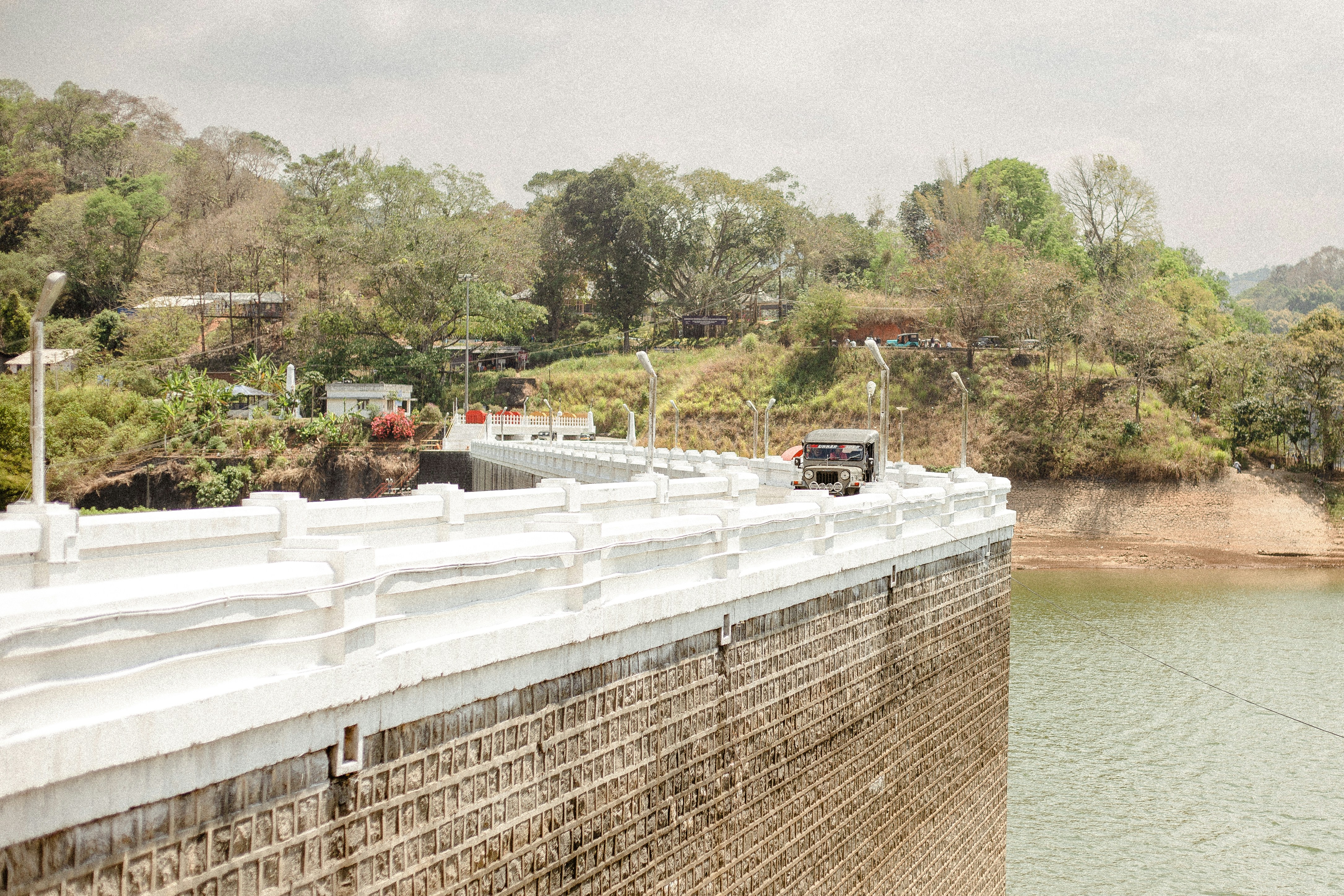 a truck driving over a bridge over a river