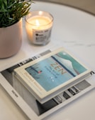 a candle and a book on a table