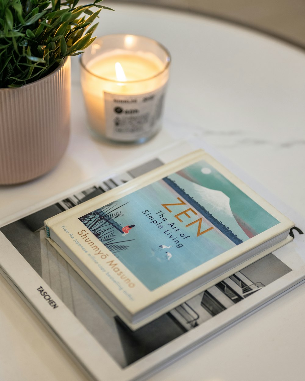 a candle and a book on a table