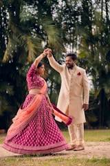 a man and a woman dancing in a field