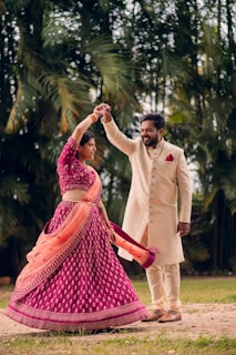 a man and a woman dancing in a field