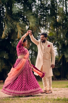 a man and a woman dancing in a field