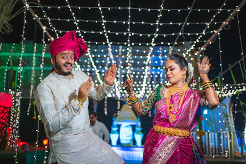 a man and woman dancing in front of lights