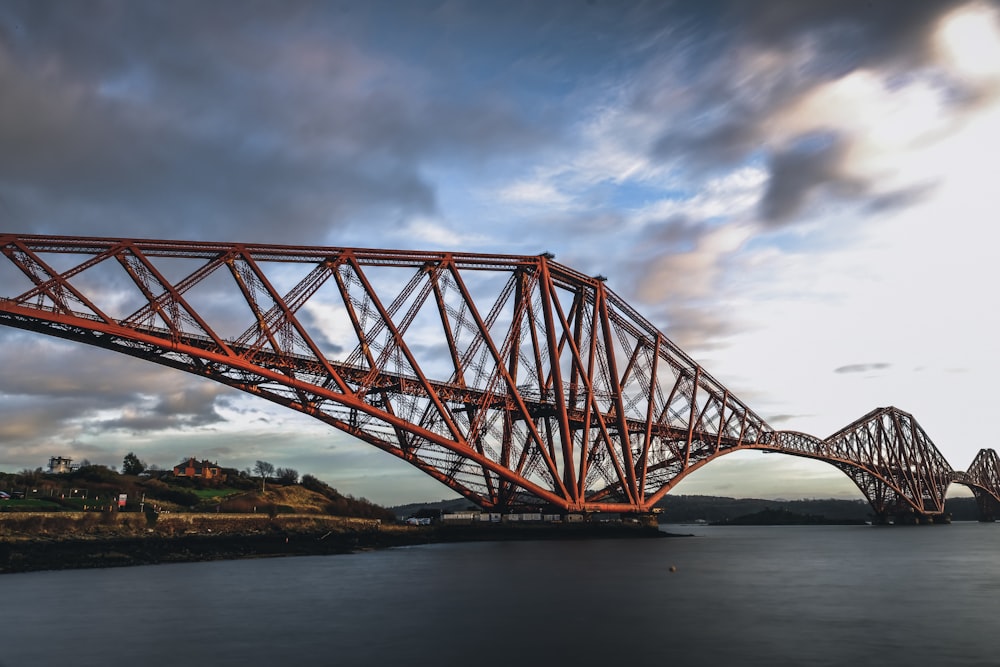 a large red bridge over a large body of water