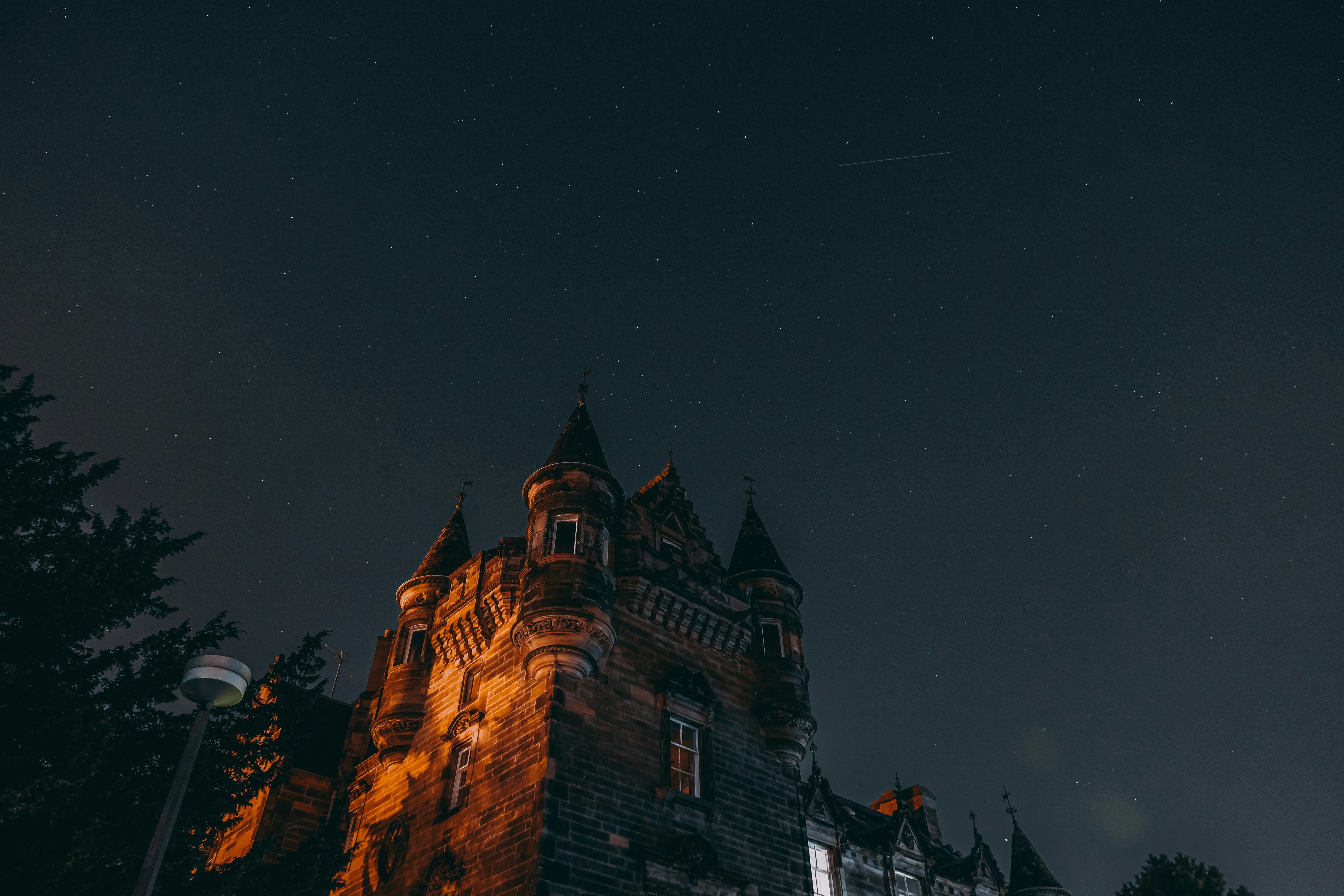 a castle at night with stars in the sky